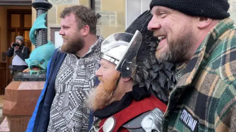 Ross Cowper-Fraser GuizerJarl, Lynden Nicolson, is posing for a photo with brothers Tom and Luke Stoltman, winners of the European and World Strongman titles.