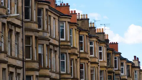 Getty Images Close up of terraced houses on a residential street in Glasgow