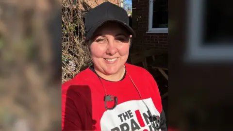 Family Handout Ms Battershall wearing a red top