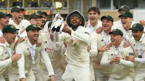 Haseeb Hameed lifts the County Championship trophy at Trent Bridge 