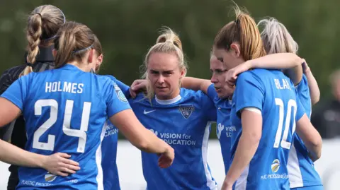 Durham Women FC in a huddle