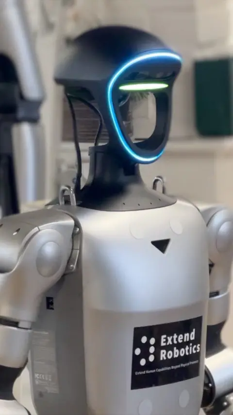 A robot with a blue LED outline and and a green LED outline is on its face.