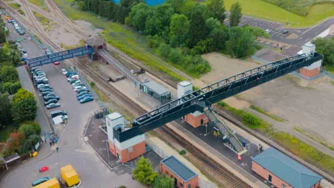 Tees Valley Combined Authority An aerial view of the station after improvements were completed. The old bridge is only accessible via two ramps either side. However, the new bridge is connected by both stairs and elevators which link directly to both car parks.