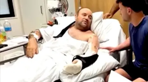 Ahmed Al Ahmed given a GoFundMe cheque in his hospital bed