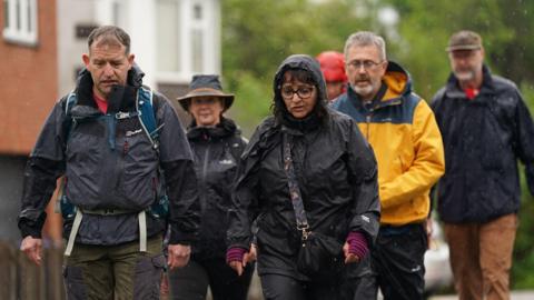 Figen Murray (front right), the mother of victim Martyn Hett, in Hinckley, Leicestershire,  with other walkers