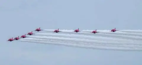 Walton Holymoorside School Red Arrows flying away from the school