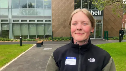 Photograph of Emma Clayton from Marple. She is pictured outside one of the buildings at the Seashell Trust in Stockport.