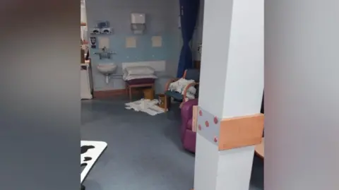 Contributor's photo Towels cover a patient chair and some towels cover part of the floor in a patient area of the cancer unit at the Royal Sussex County Hospital.