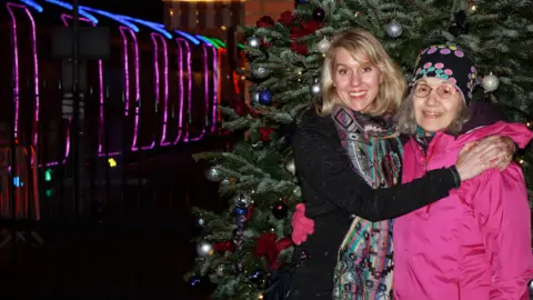 Scott Williams Kristin Dore and mother Jeanne in front of the Train of Lights