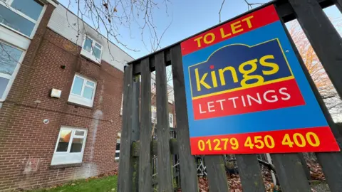 Stuart Woodward/BBC Kings Lettings agency billboard sign outside Sycamore Field flats in Harlow