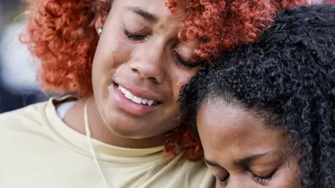 EPA Two girls are crying at the vigil