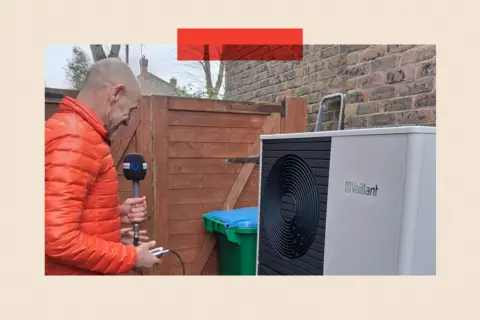 Evan Davis inspects a Vaillant heat pup