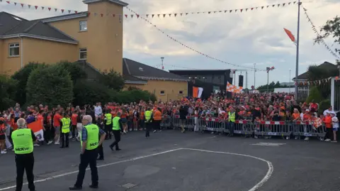 A crowd of Armagh supporters. Some are waving flags