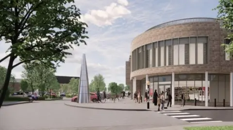Solihull Council The same building as above, viewed from the side instead of the front. There is a pedestrian crossing going over a road and what looks like a small supermarket is on the ground floor of the building. There is a large silver cone-shaped sculpture on the pavement outside.
