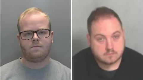 A custody image of Ethan Towers is on the left. He has short blond hair and is wearing black framed glasses and a grey T-shirt. He is standing in front of a grey wall. On the right is a custody image of John Watson who has short brown hair and is wearing a black T-shirt. He is sitting in front of a grey wall.