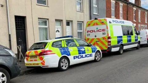 Police vehicles parked in Princes Street in Normanton, Derby