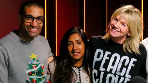 Richie Anderson, Tina Daheley and Zoe Ball hug during Zoe Ball's last Radio 2 Breakfast Show in December 2024