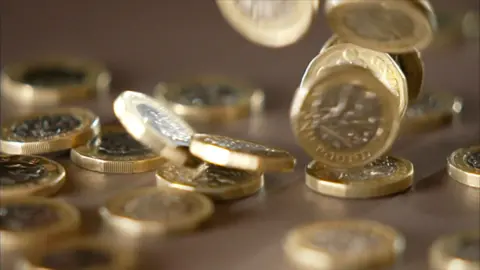 A collection of £1 coins on a table
