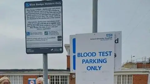 Terry Nicholls There are two signs next to each other. One says blue badge holders only. Another says blood test parking only. 