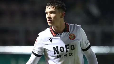 Harrison Burke in Walsall's white change strip