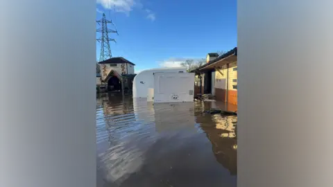 Sarah Reilly A trailer submerged in floodwater 