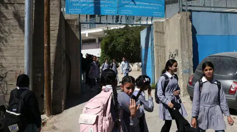 Palestinian schoolgirls leave an Unrwa school in Shuafat refugee camp in Israeli-annexed East Jerusalem (8 May 2025)
