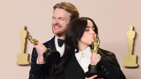 Getty Images Billie Eilish and her brother Finneas O'Connell at this year's Oscars