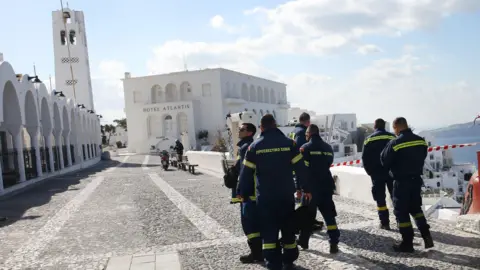 EPA Firefighters in the nearly fully evacuated village of Fira in Santorini on Thursday