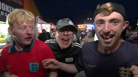Three men stood in a group after the match, all three looking particularly jubilant.