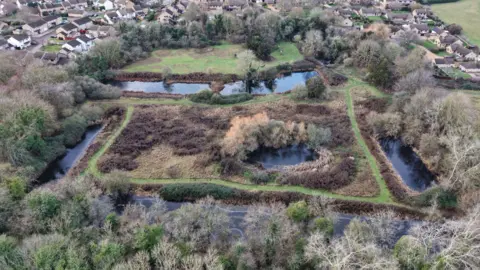 Peterborough From Above A drone image of the ponds surrounded by green trees and bushes. 