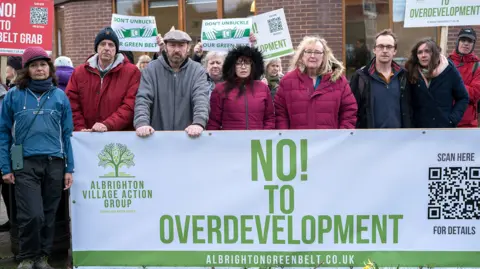 Albrighton Village Action Group People with a protest banner