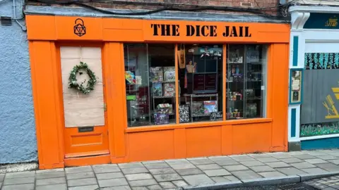 The Dice Jail The exterior of The Dice Jail shop, in Southwell, which is painted bright orange