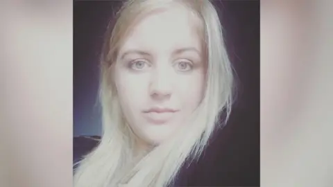 Family photo Abbigail Smith with blonde hair and wearing a black top