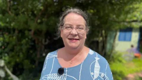 Alex Bish/BBC Lucy Moreton standing in her garden