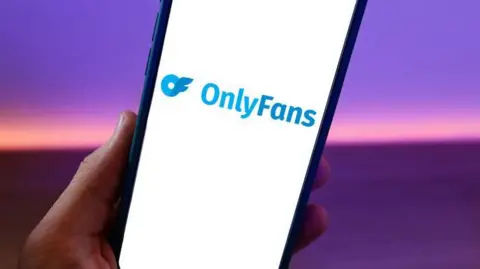 NurPhoto / Getty Images A phone with the OnlyFans logo on the screen
