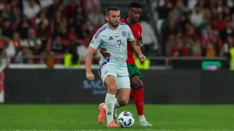 Getty Images Scottish football John McGinn tries to escape Nelson Semedo of Portugal (B) during the UEFA Nations League 2024/25 League A Group A1 match between Portugal and Scotland at on September 8, 2024 in Lisbon, Portugal.