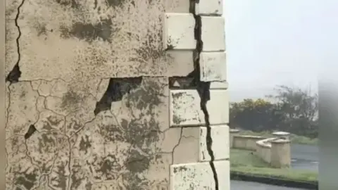 Bigger Picture Project Large cracks in the brickwork of a house affected by mica