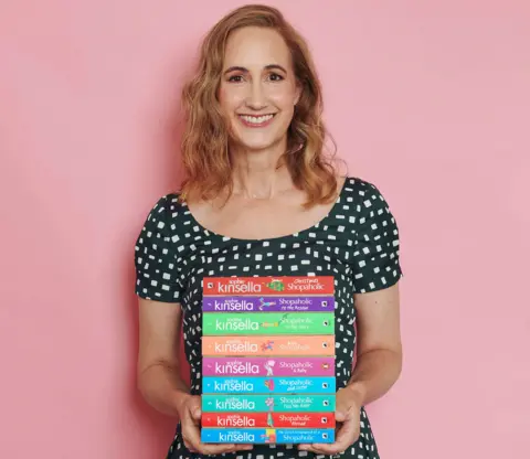 Sarah Cresswell Sophie Kinsella pictured with hr Shopaholic series of novels