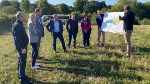 Chesterfield Borough Council Developers, Chesterfield Borough Council leader Tricia Gilby and MPs Louise Jones and Toby Perkins look at prospective plans for the scheme in a field where a bypass would go