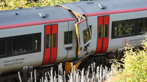 PA The scene after a collision involving two trains near Llanbrynmair, Mid Wales. A door is crumpled. 