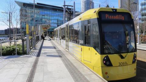 A Metrolink tram about to depart the platform at MediaCity in Manchester, headed for Piccadilly in the city centre