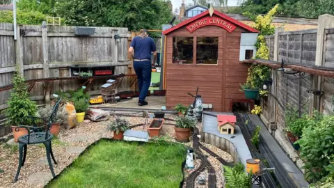 Railway garden with lots of G Scale brass tracks down and ornaments