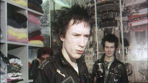 The Sex Pistols wearing leather jackets in Vivienne Westwood's clothing store.