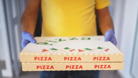 Getty Images man delivering pizza