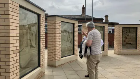 A man talking to someone about the newly-installed stones