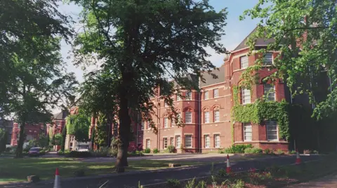 County Asylums Four storey red brick institutional buildings with trees in front