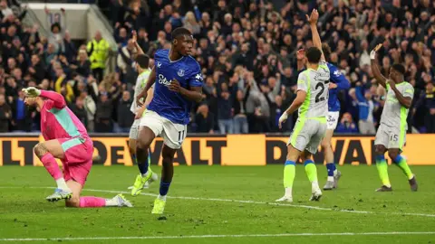 Everton's Thierno Barry celebrates scoring his side's second goal as Manchester City players appeal for offside