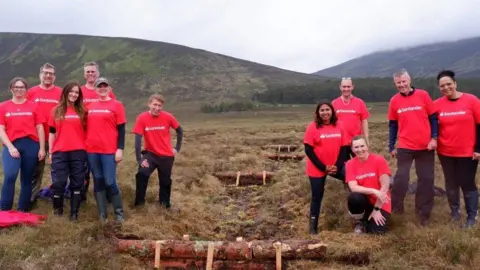 National Parks Partnerships A number of people in a national park wearing red t-shirts