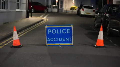 Eddie Mitchell A sign saying police accident. 