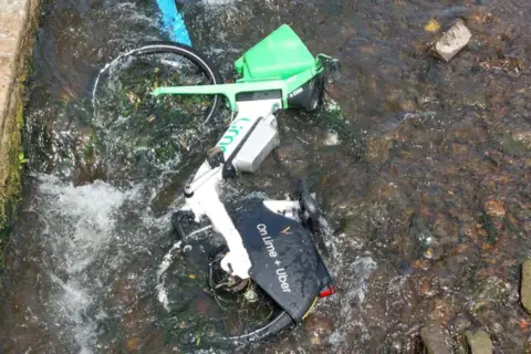 Toni Robinson A Lime bike in a shallow part of the River Leen in Nottingham